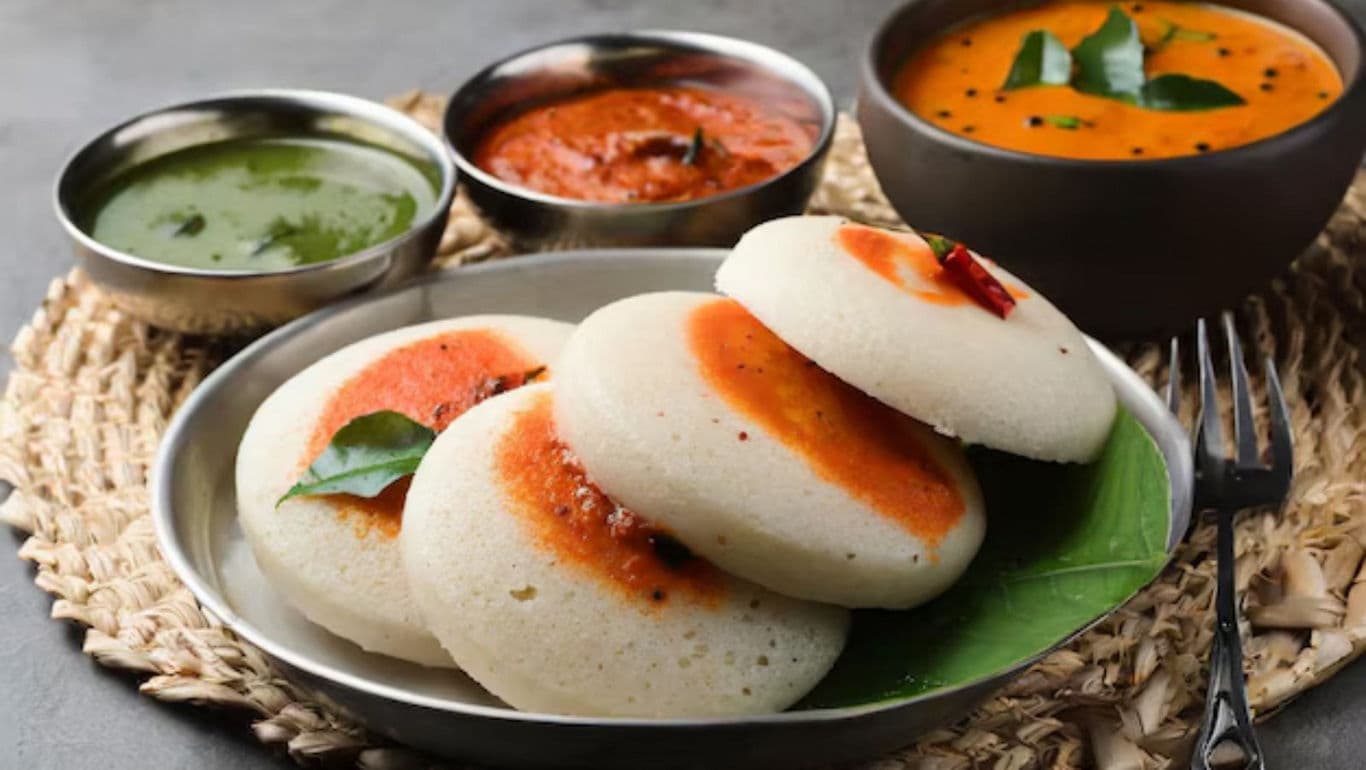 South Indian idli with chutneys and sambar served