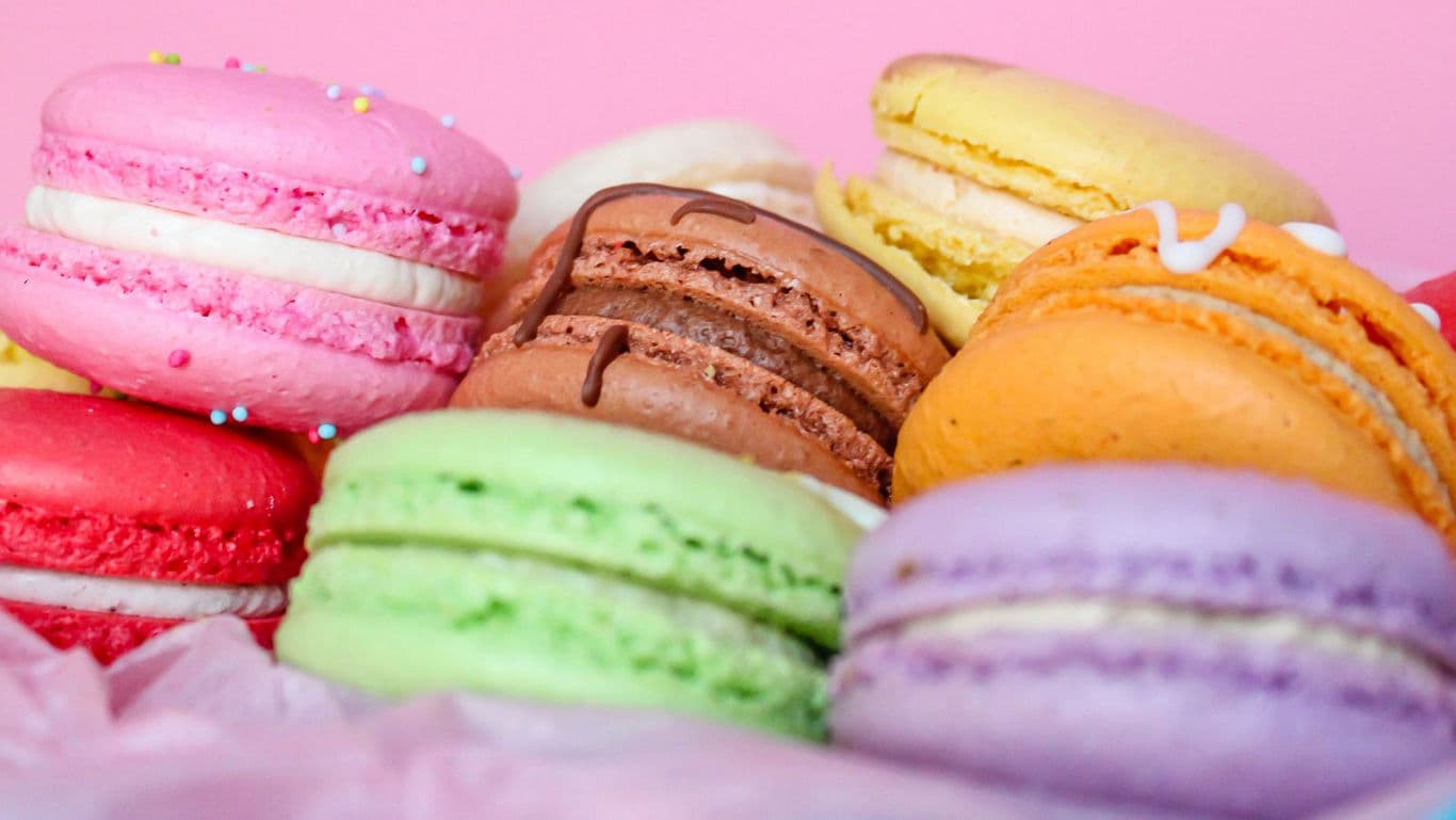 Colorful Assorted Macarons on Pink Background