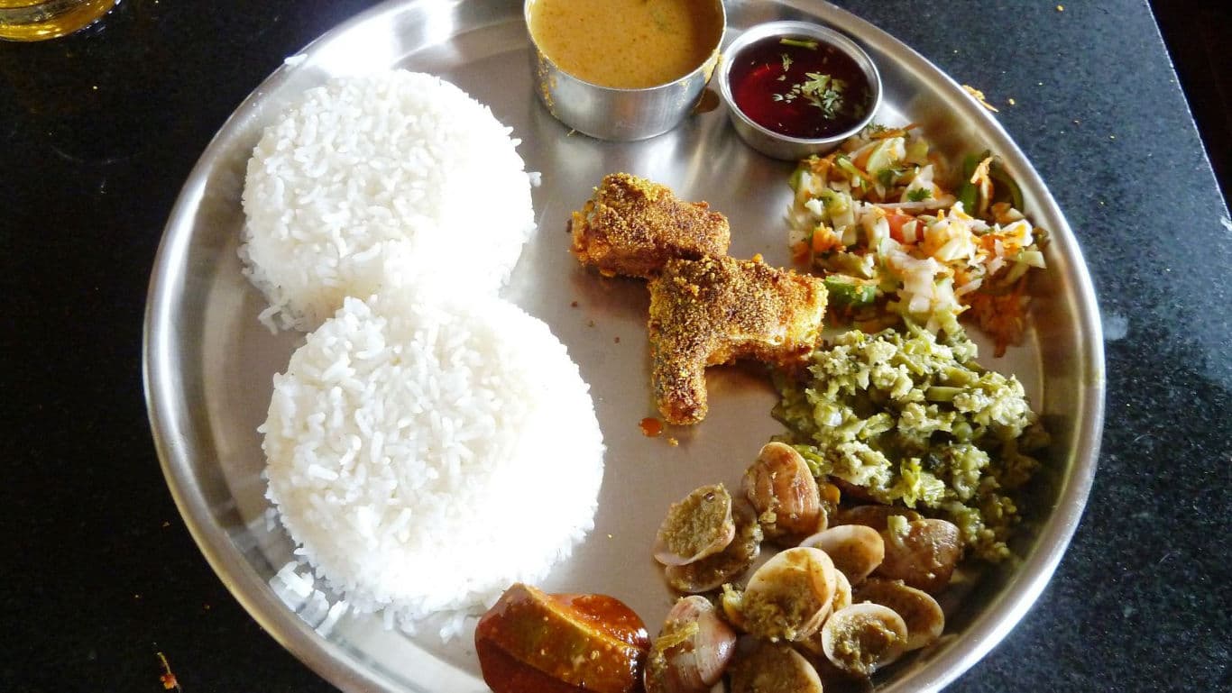 Traditional Indian thali with rice and assorted dishes