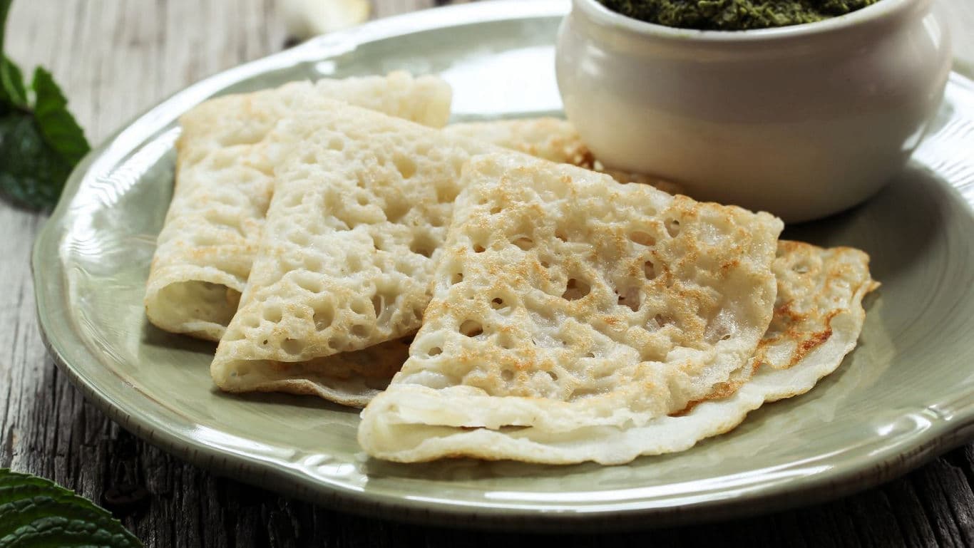 Thin spongy crepes served with green dip