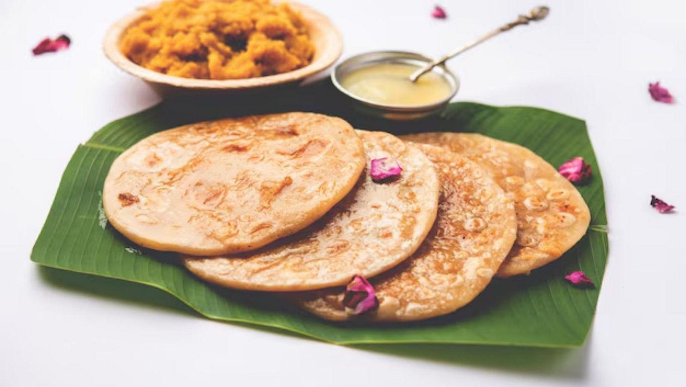 Traditional Indian sweet pancakes on banana leaf