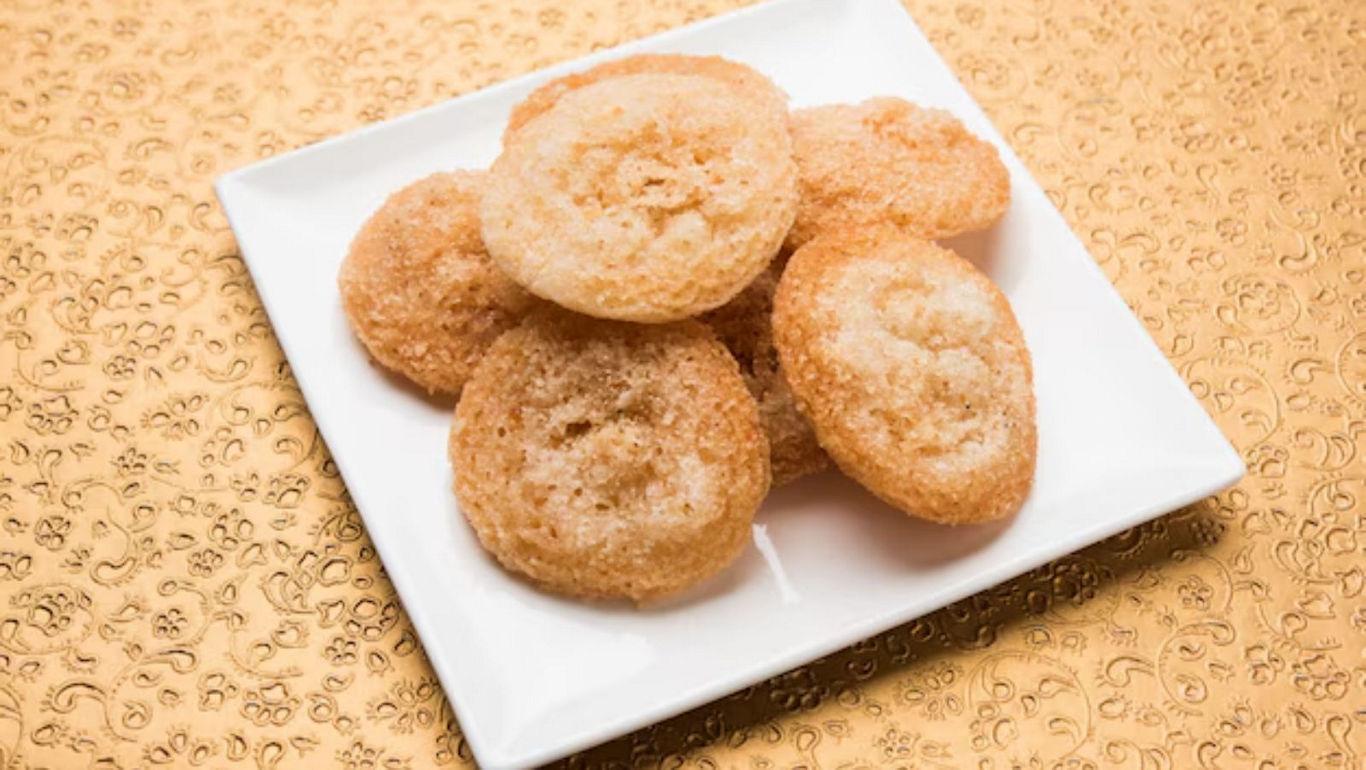 Golden sugar cookies on white plate