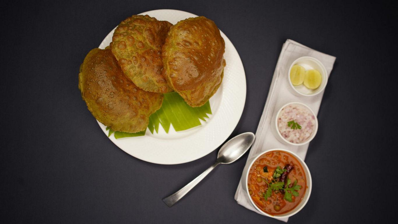 Indian fried bread with curry and sides