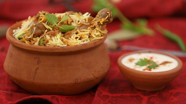 Kolkata biryani with raita on the side. 