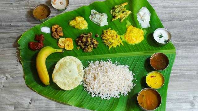 Traditional Onam Sadya feast served on a banana leaf with various Kerala dishes.