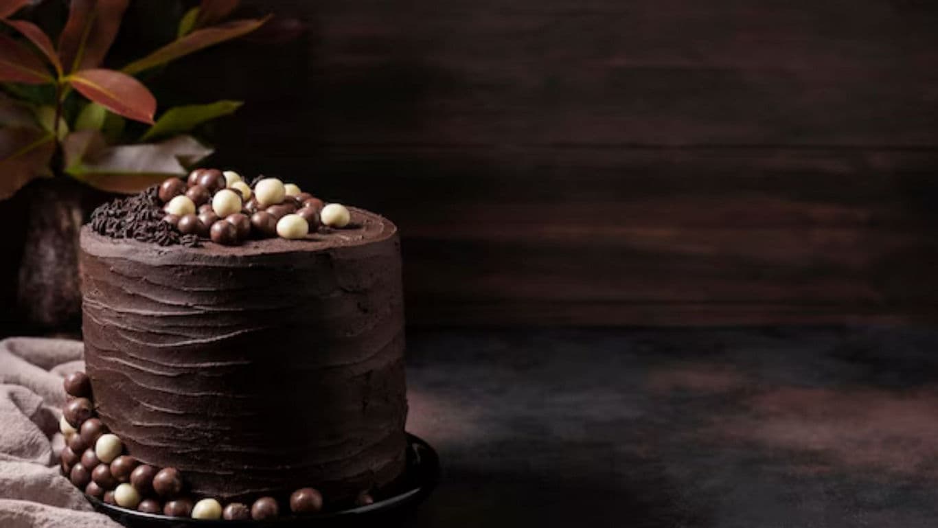 Tall chocolate cake with assorted candy decorations