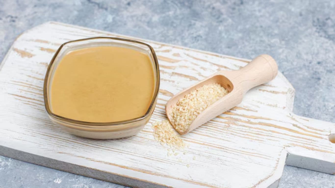 Bowl of Tahini with Sesame Seeds on Board
