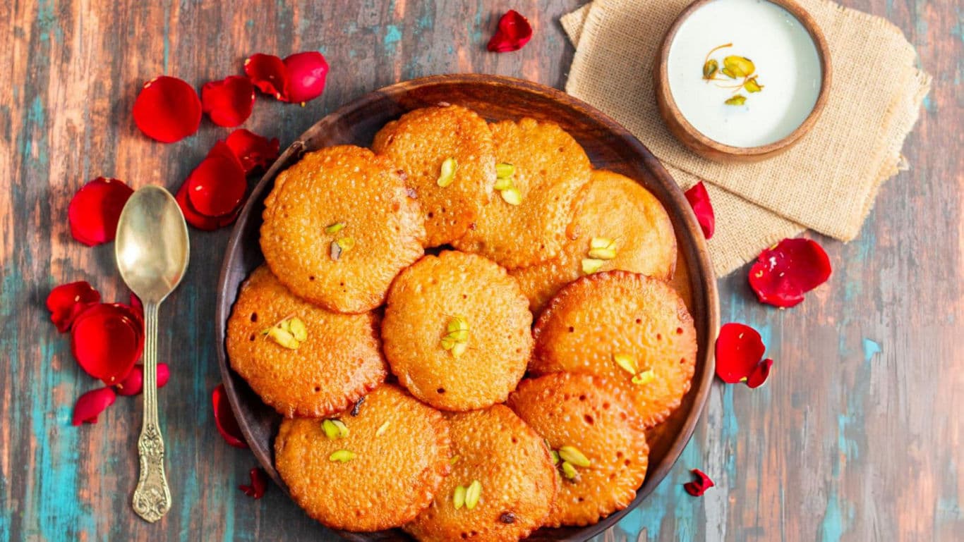 Malpua with rabri on a plate.
