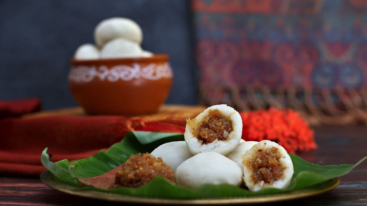 Manda pitha sliced open on a plate