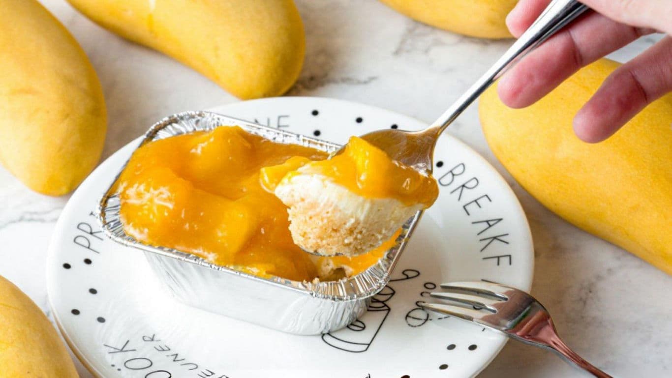 Mango dessert in foil tray with spoon