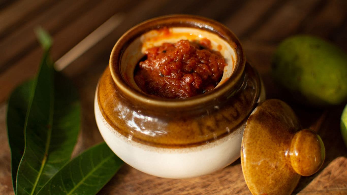 Mango pickle in a ceramic jar.