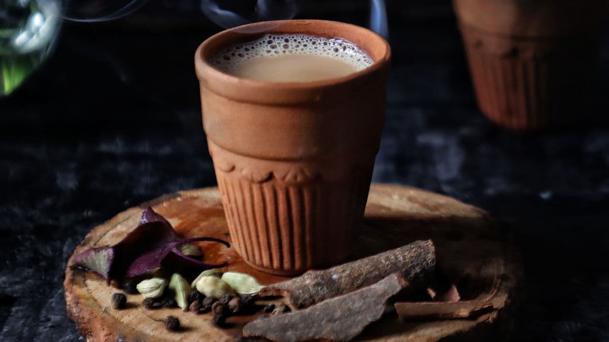 a glass of tea with adrak on the side