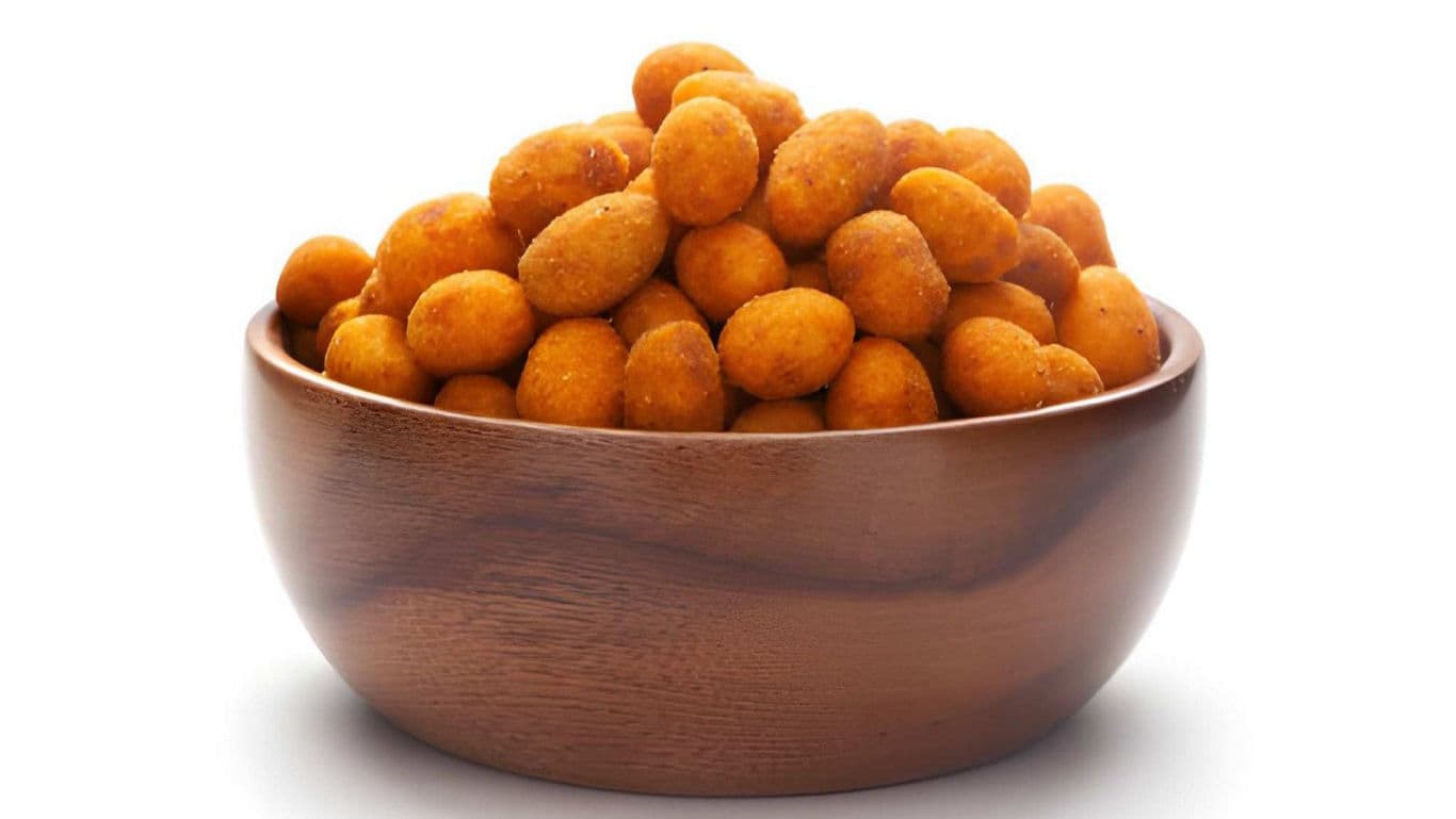 Wooden bowl filled with crunchy coated peanuts