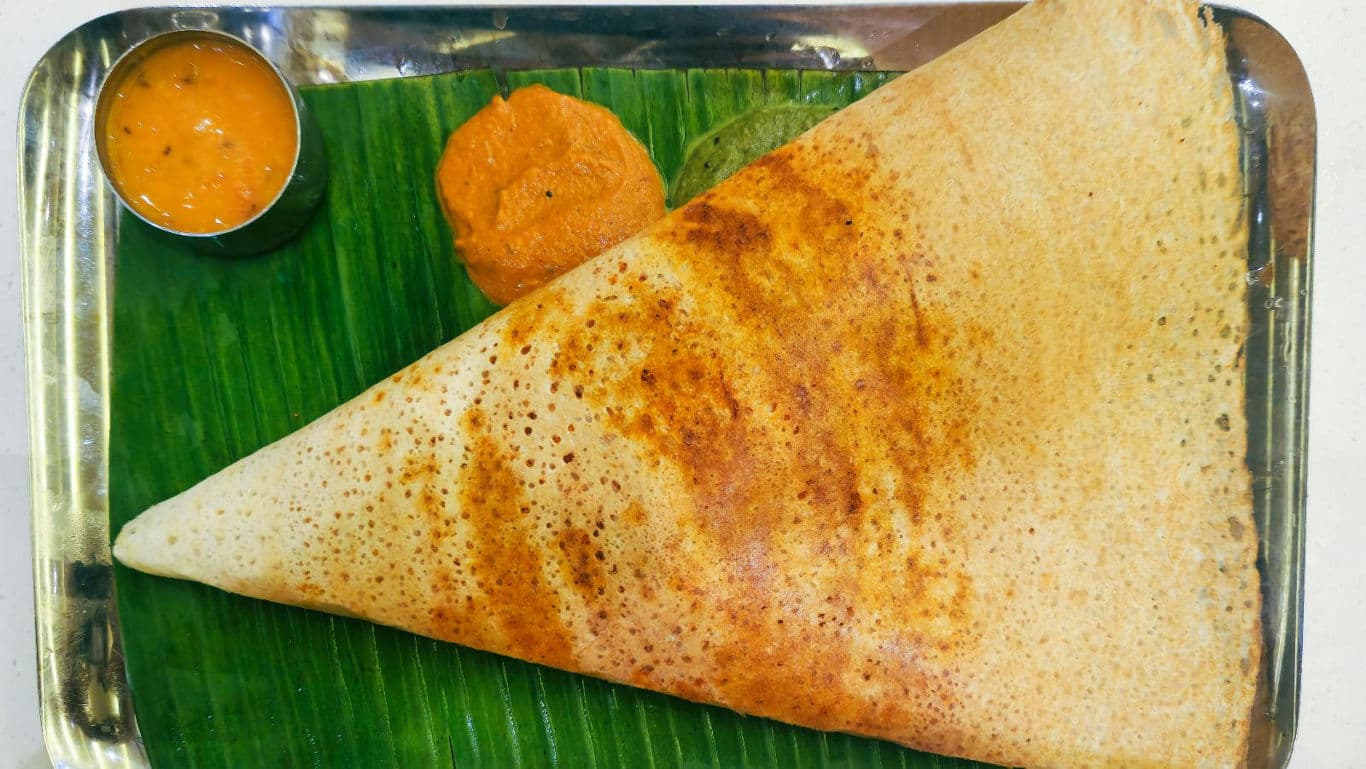 Crispy masala dosa on banana leaf