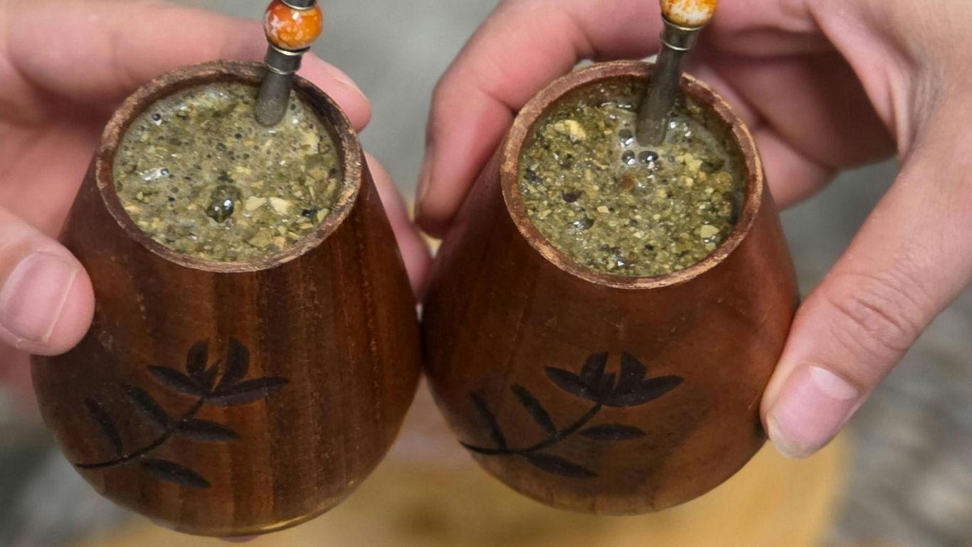 Two wooden mate cups with metal straws