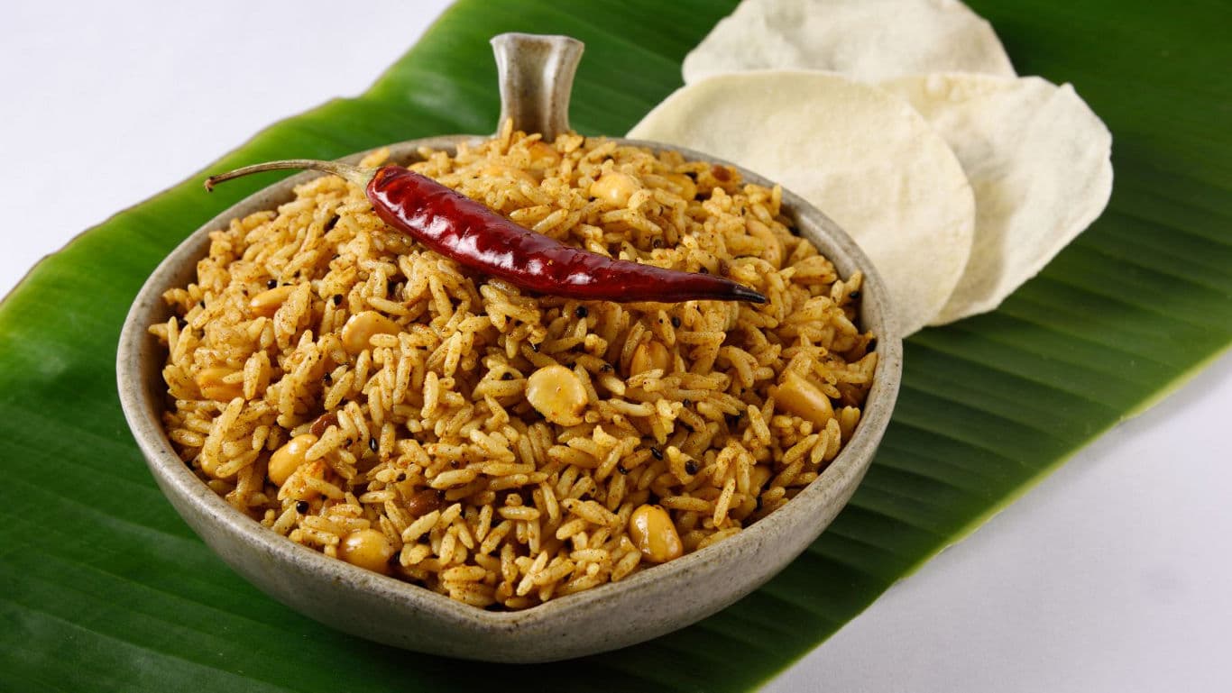 Spicy South Indian Rice with Papad on Banana Leaf