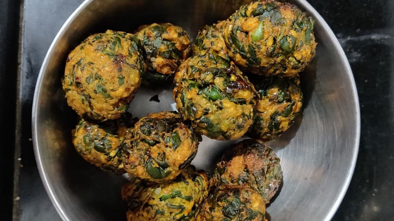 Crispy spinach fritters in metal bowl