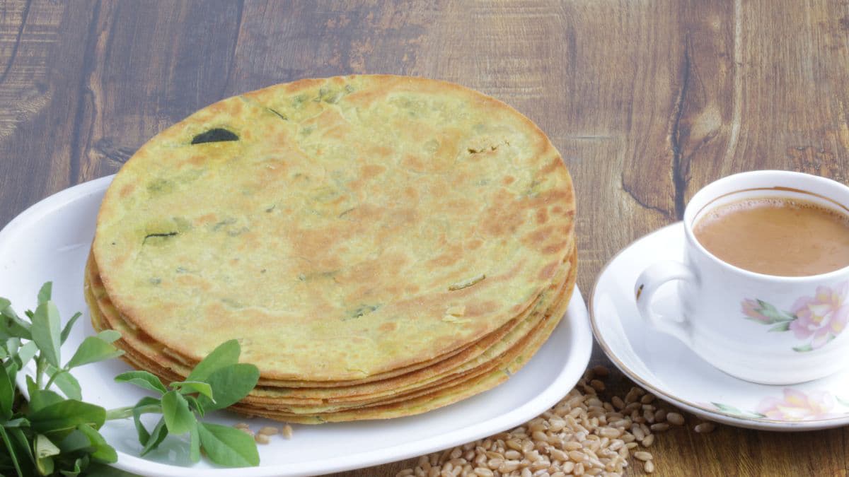 Stack of light green khakhra with a cup of tea