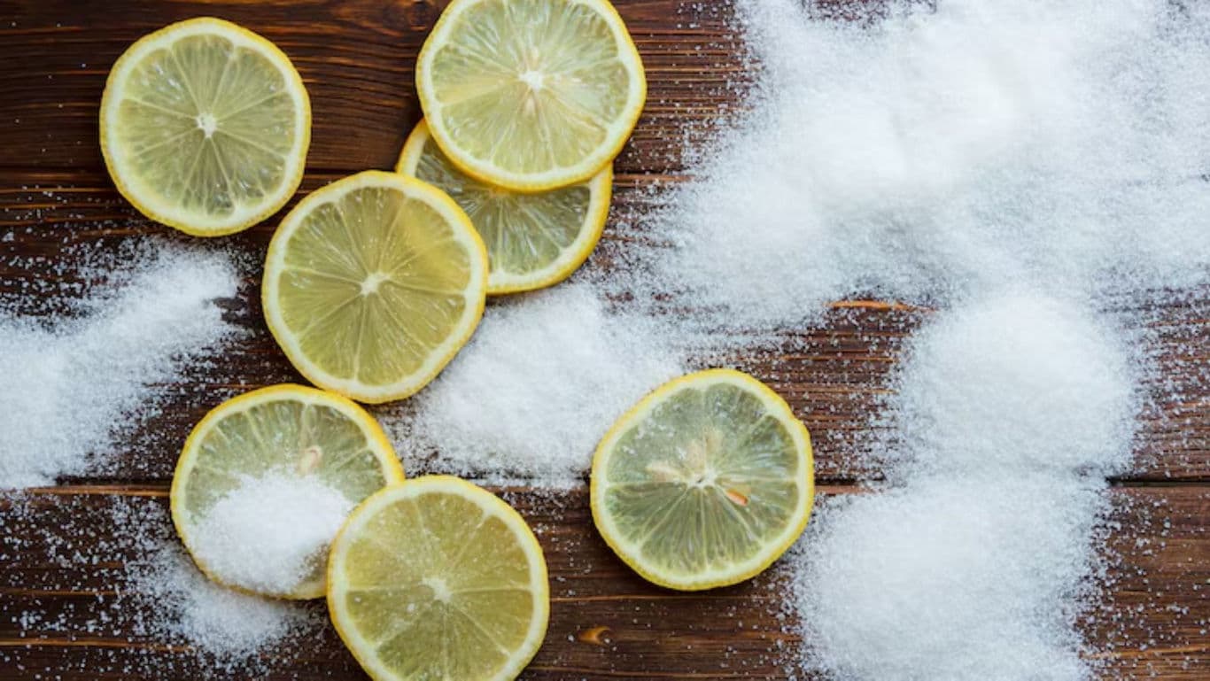Lemon slices with scattered sugar on wood
