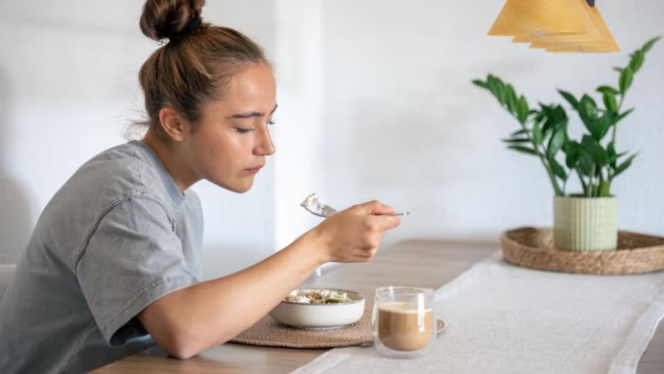Woman enjoying breakfast with coffee
