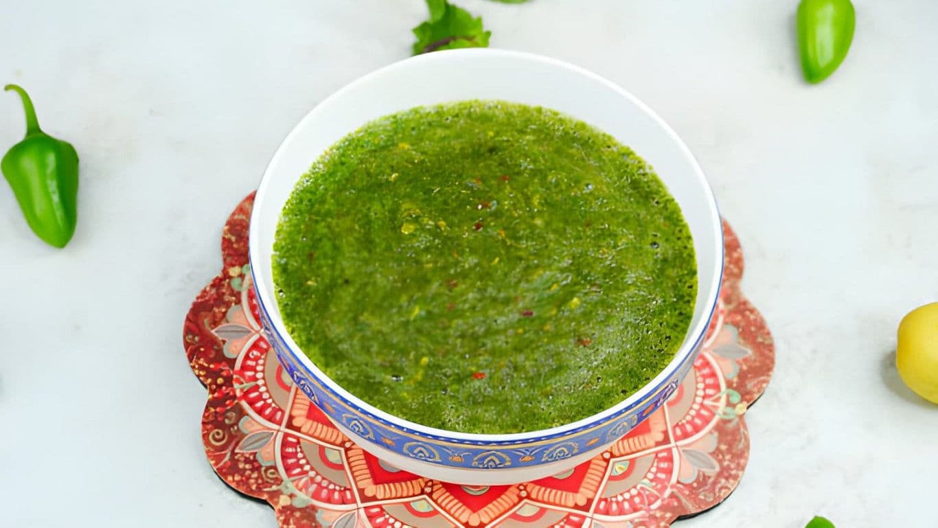 Fresh green chutney in decorative bowl overhead