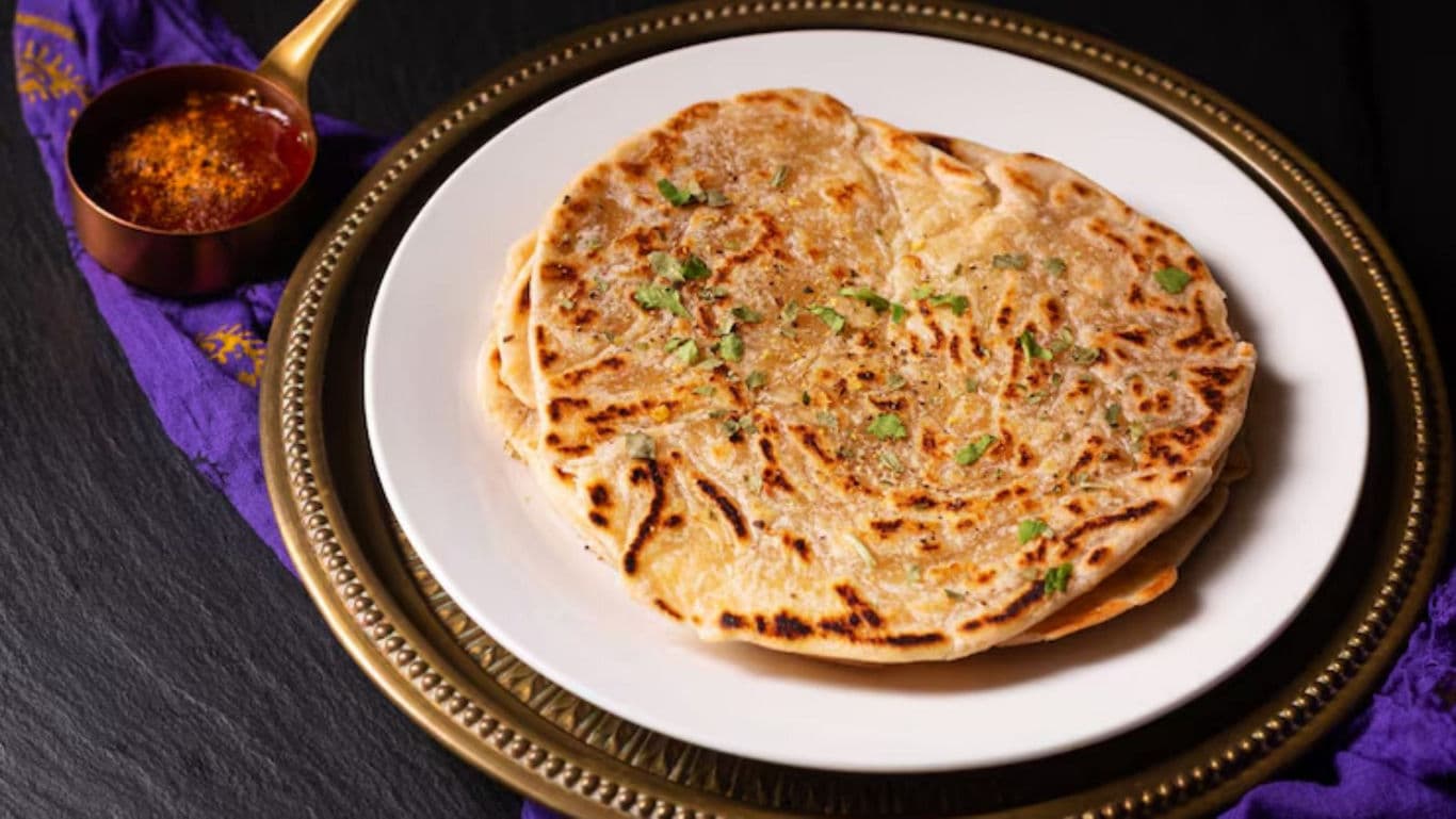 Stuffed paratha served with spiced chutney