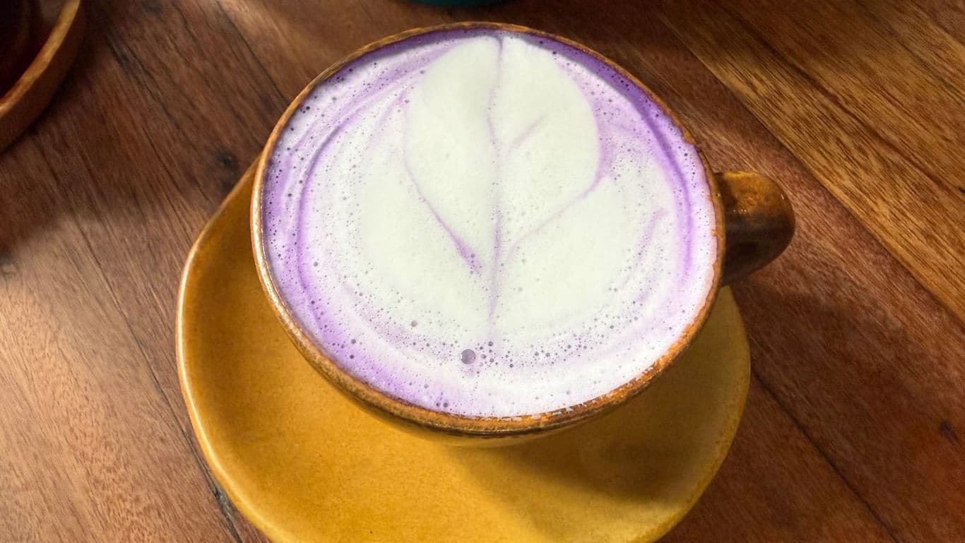 Lavender latte art in yellow ceramic cup