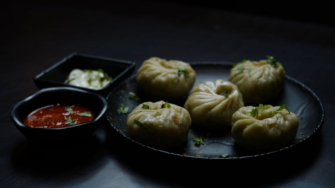 Steamed momos with spicy red chutney dip