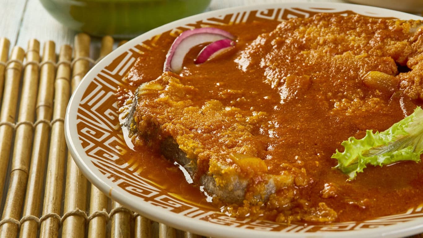 Fish steak in spicy tomato sauce on plate