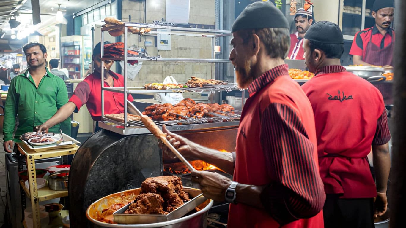 Street food vendors grilling meat at night