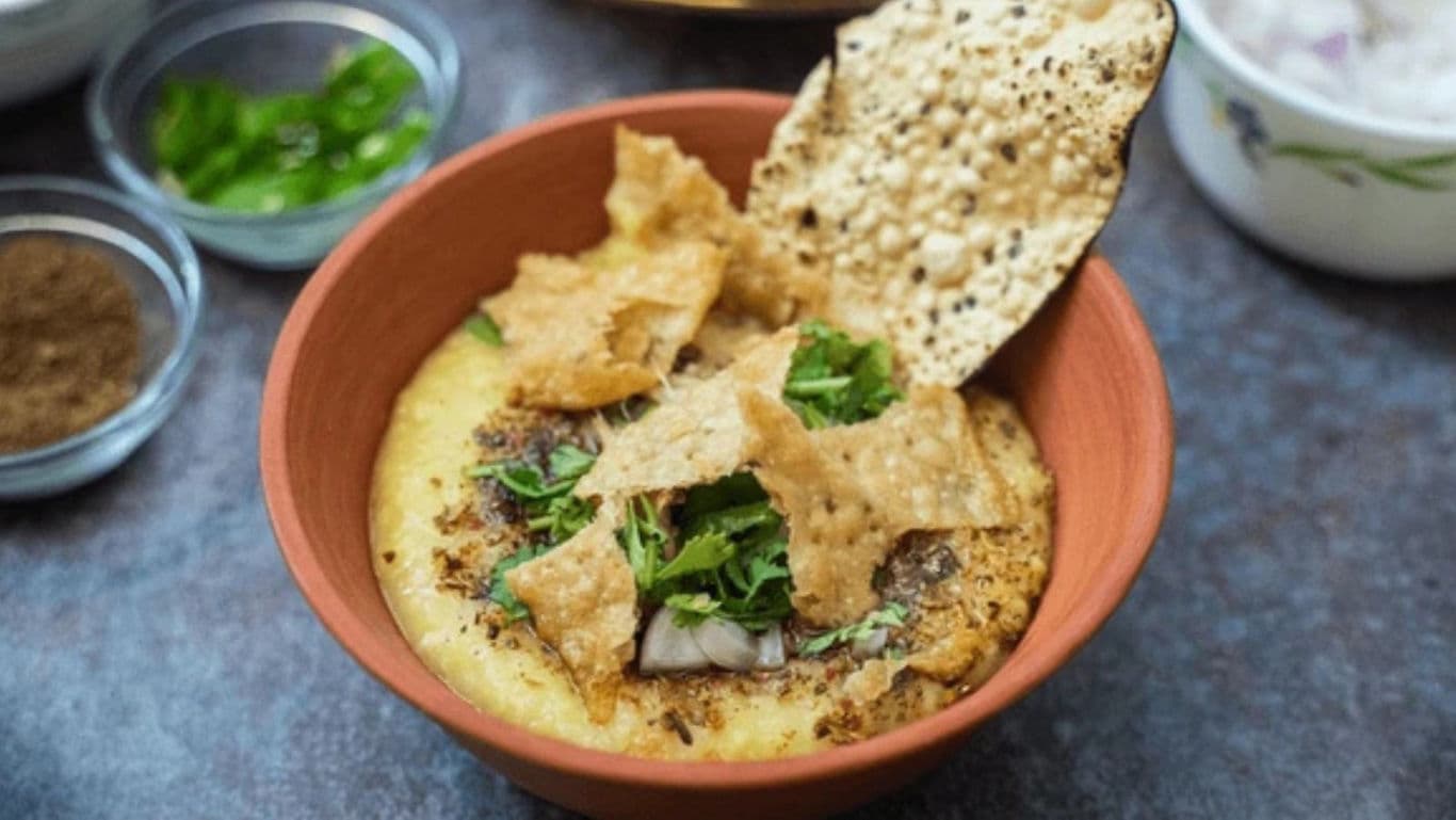 Traditional Indian khichdi served with papad in clay bowl