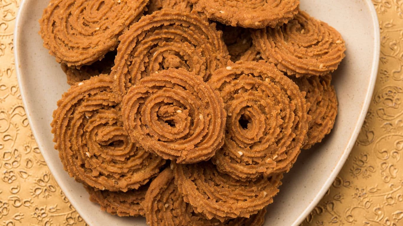 Crispy spiral snacks on white plate