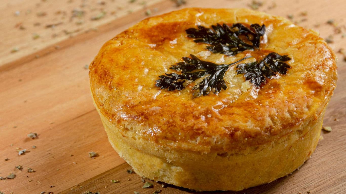 Golden savory pie with herb garnish