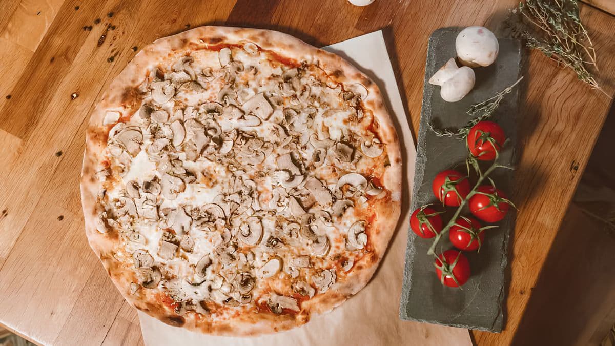 mushroom pizza on a wooden table