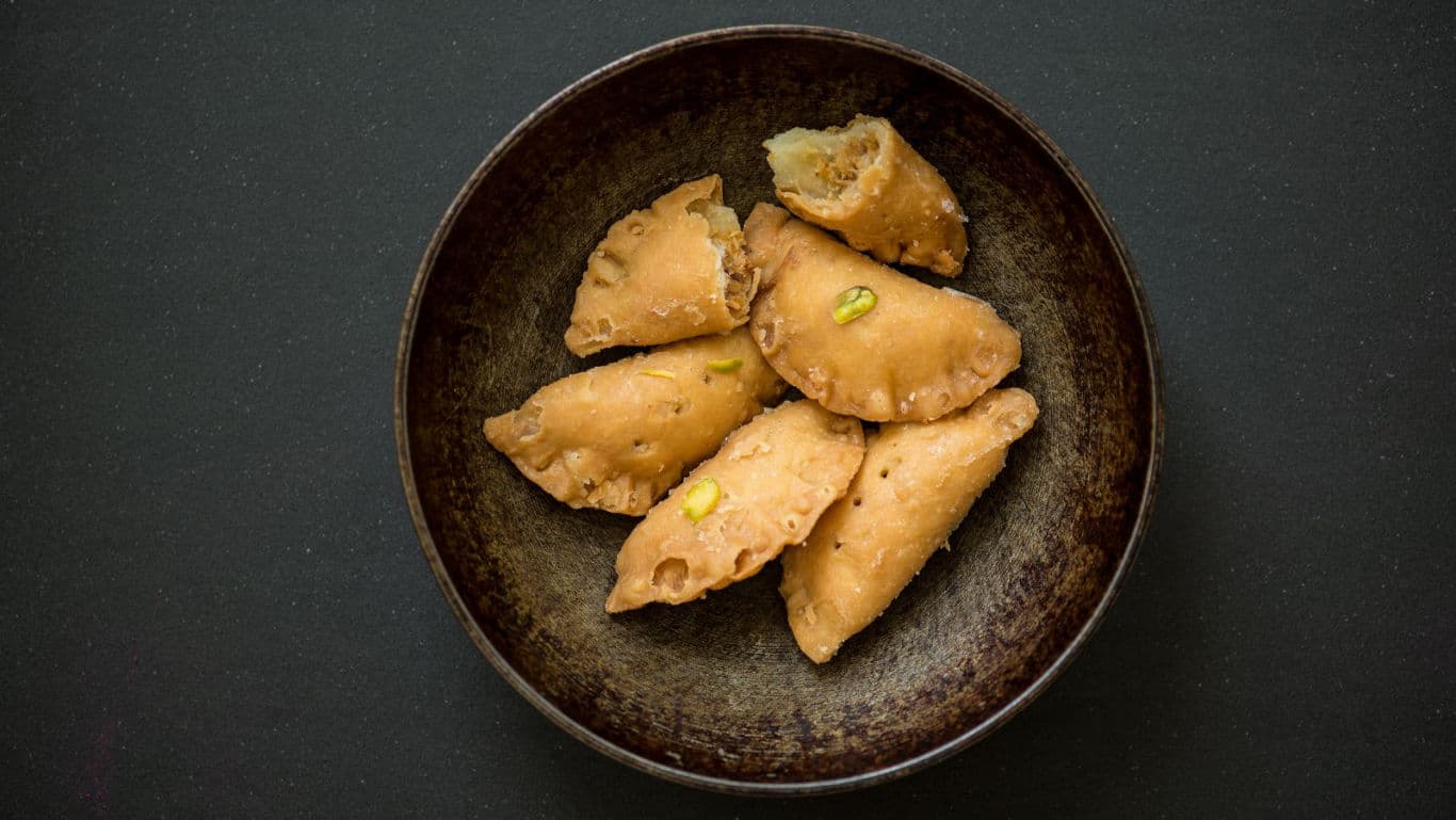 Traditional fried pastries in rustic bowl
