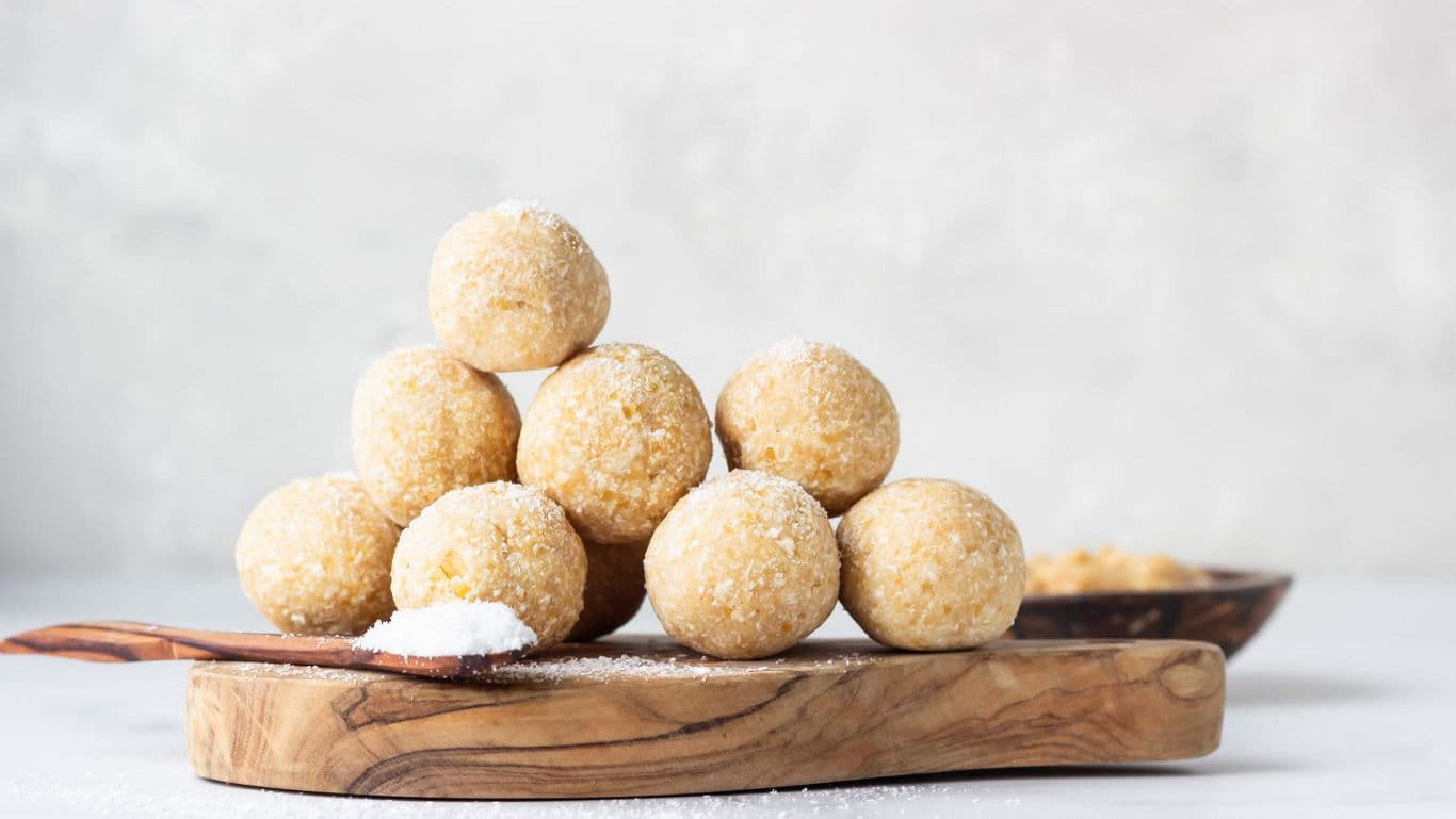 Homemade Coconut Ladoo Balls on Wooden Board