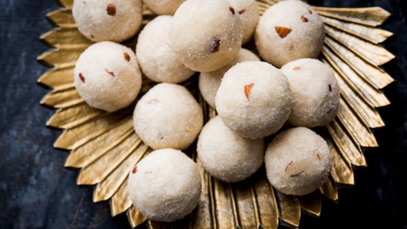 Traditional Indian coconut ladoos on golden platter