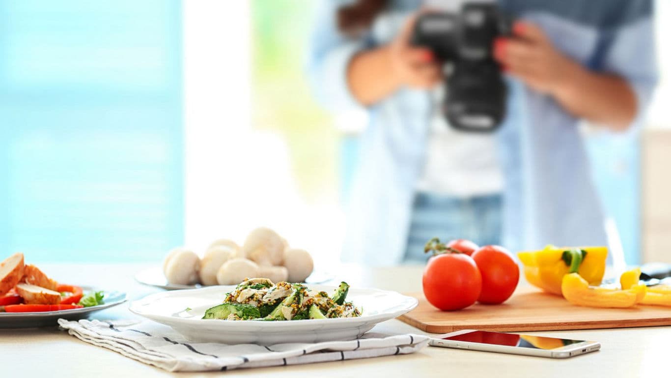 Food photographer capturing fresh vegetable dish