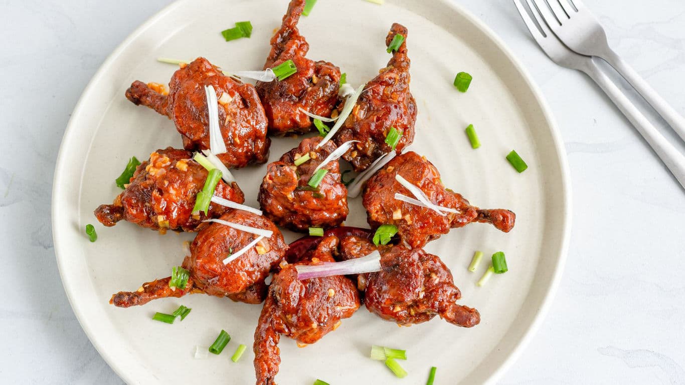 Spicy fried chicken lollipops on plate