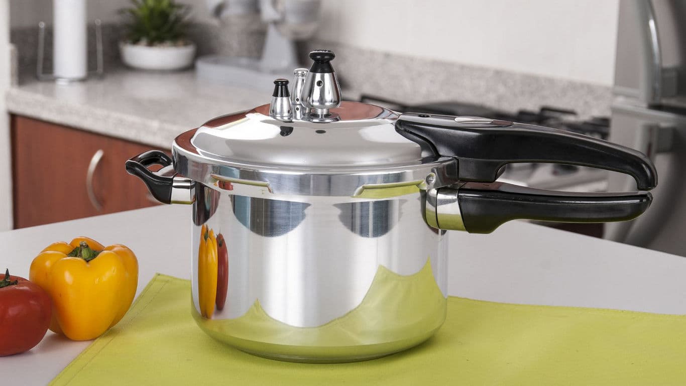 Stainless steel pressure cooker on kitchen counter