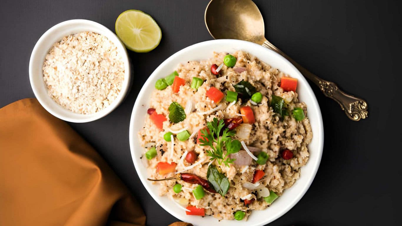 Vegetable upma served with grated coconut and lime