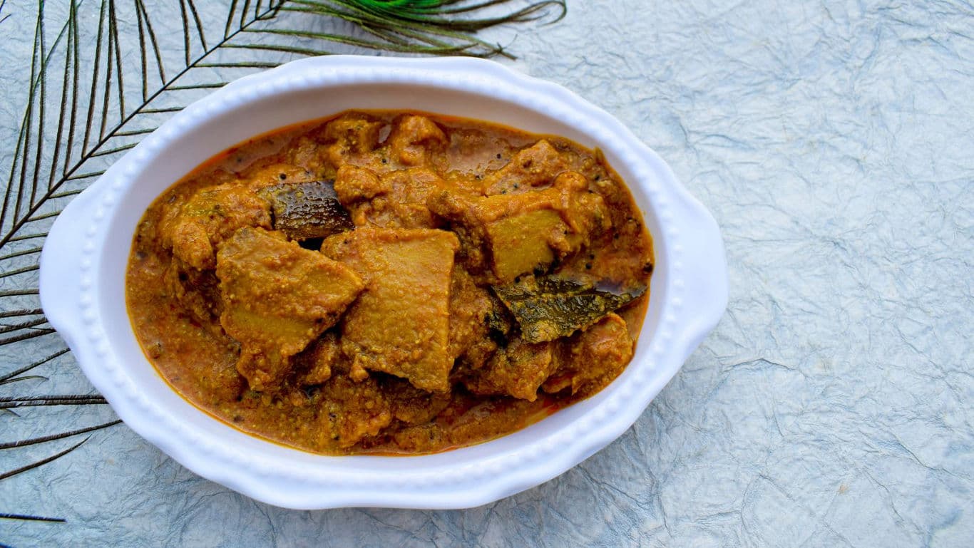 Traditional Indian curry served in white oval dish