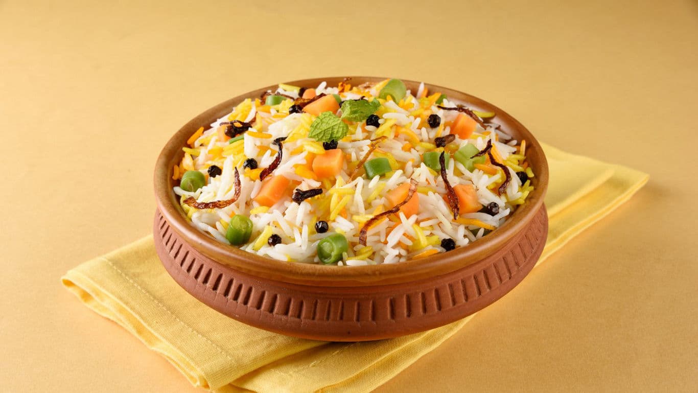 Colorful vegetable biryani served in clay bowl