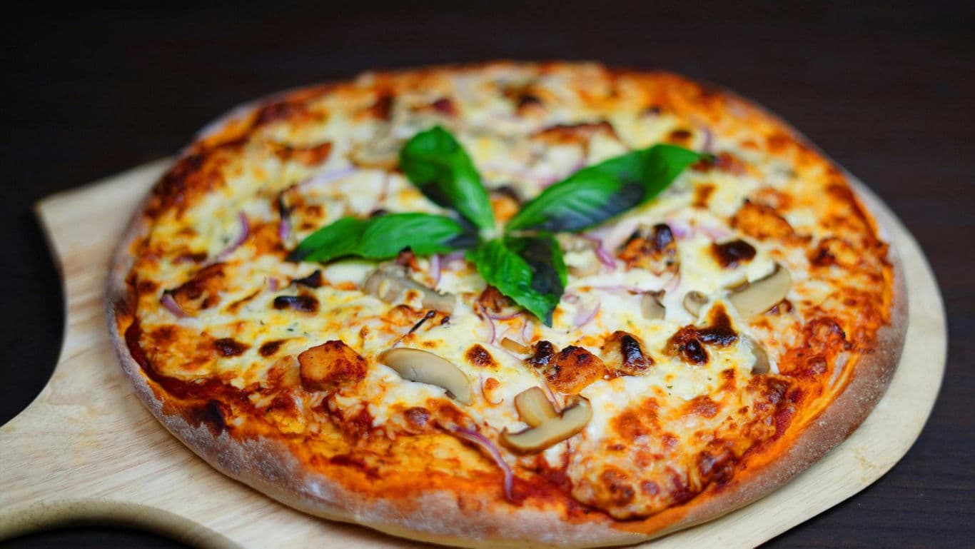 Freshly baked cheese and mushroom pizza