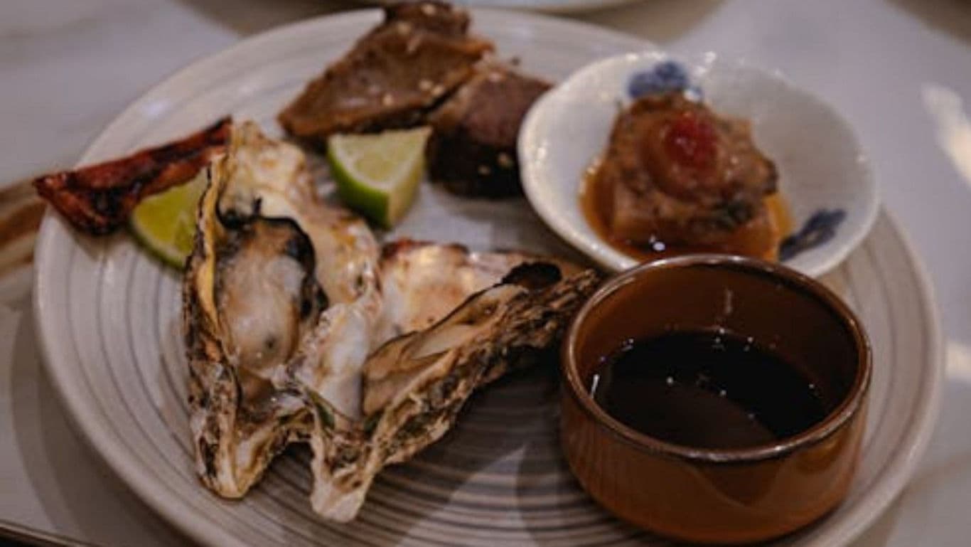 Assorted seafood platter with oysters and dipping sauce