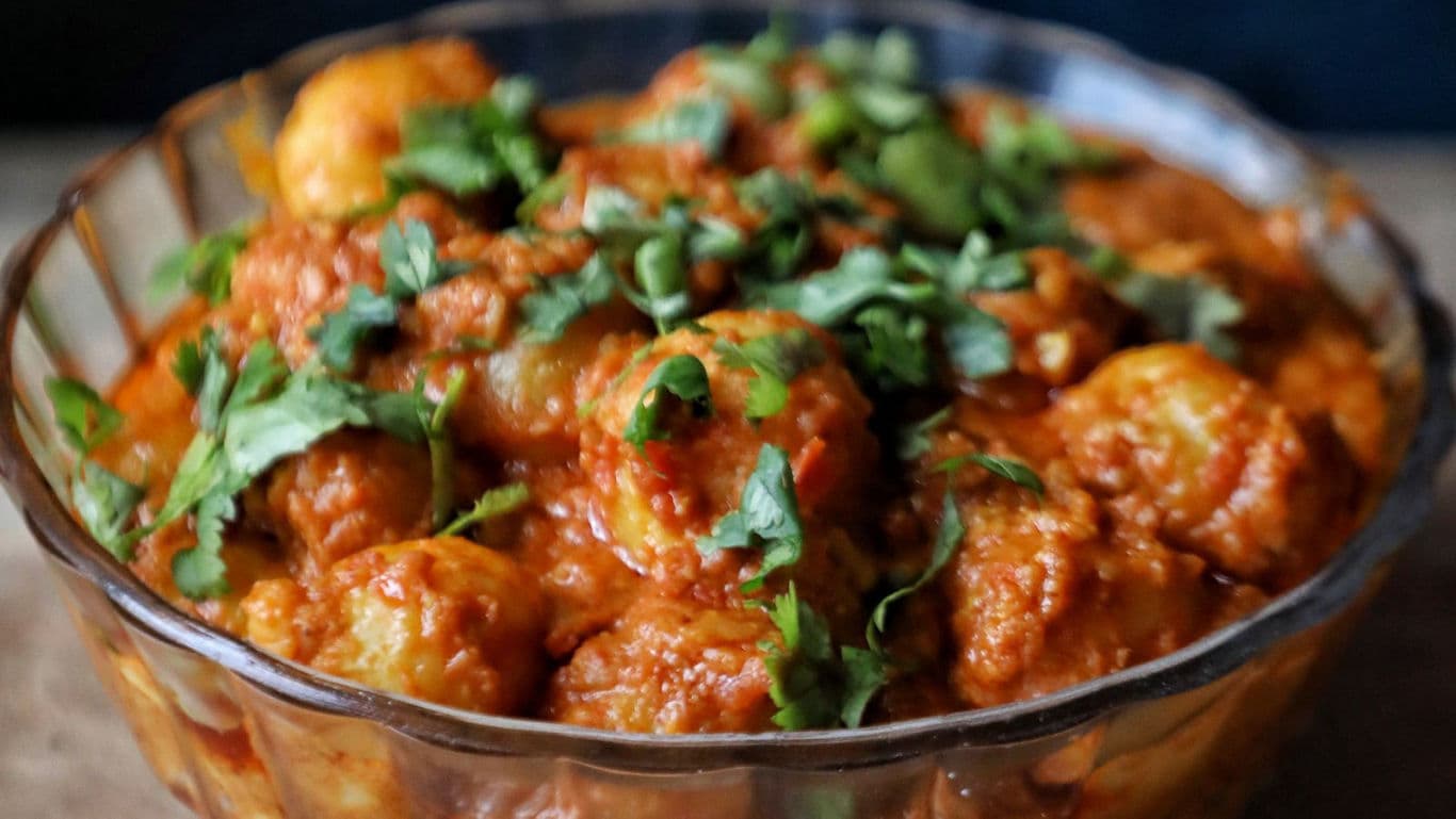 Spicy potato curry garnished with cilantro