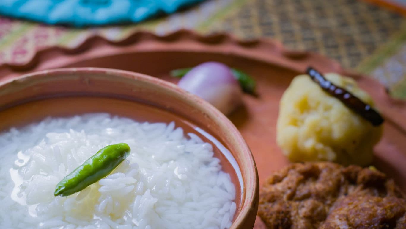 Traditional Indian Rice Meal with Sides on Clay Plate