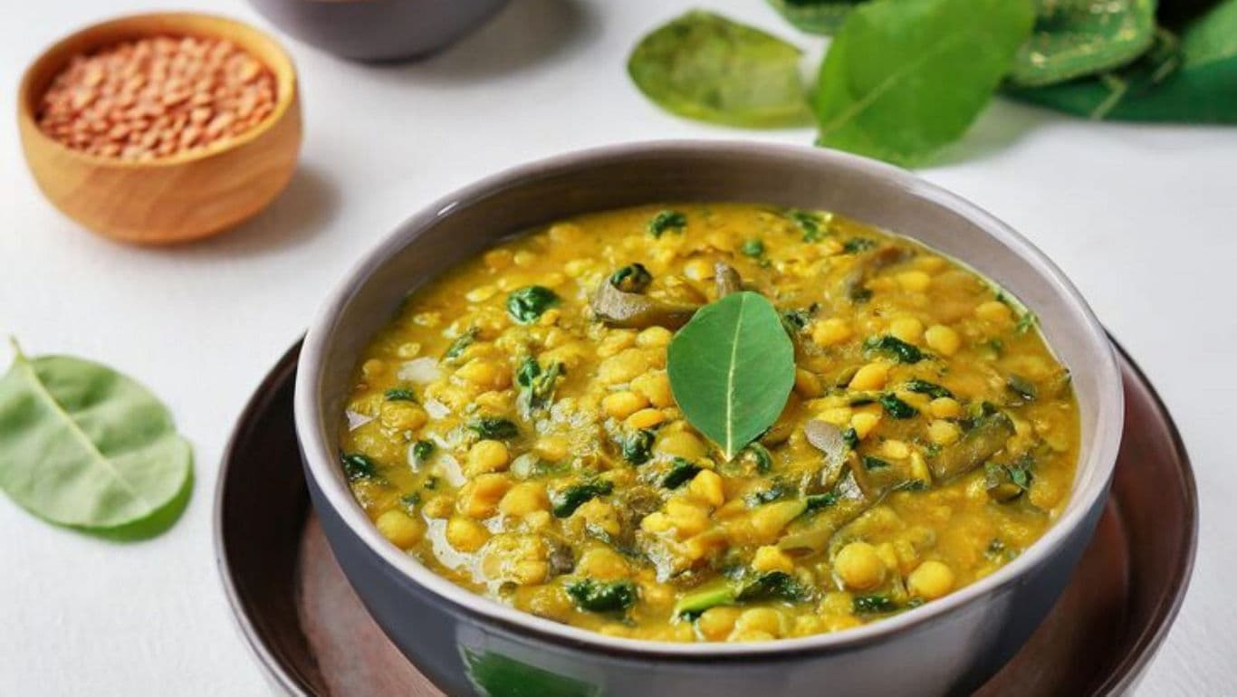 Bowl of Lentil Curry with Fresh Leaves