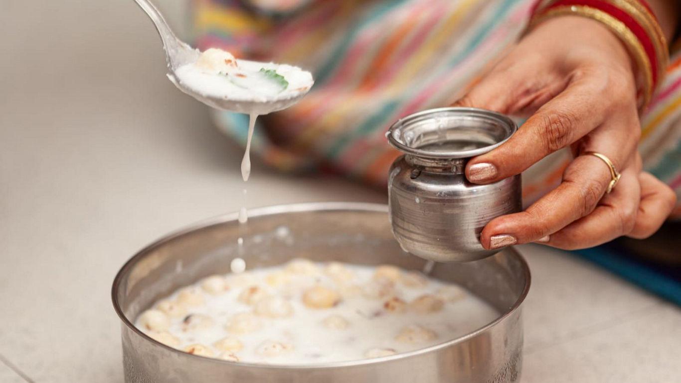 Traditional Indian dessert preparation in steel bowls