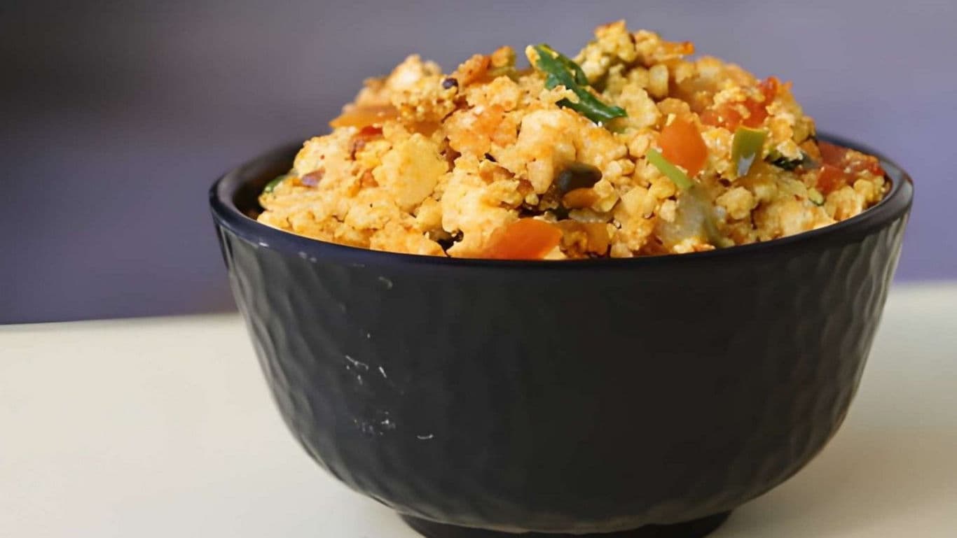 Black bowl filled with mixed vegetable scramble